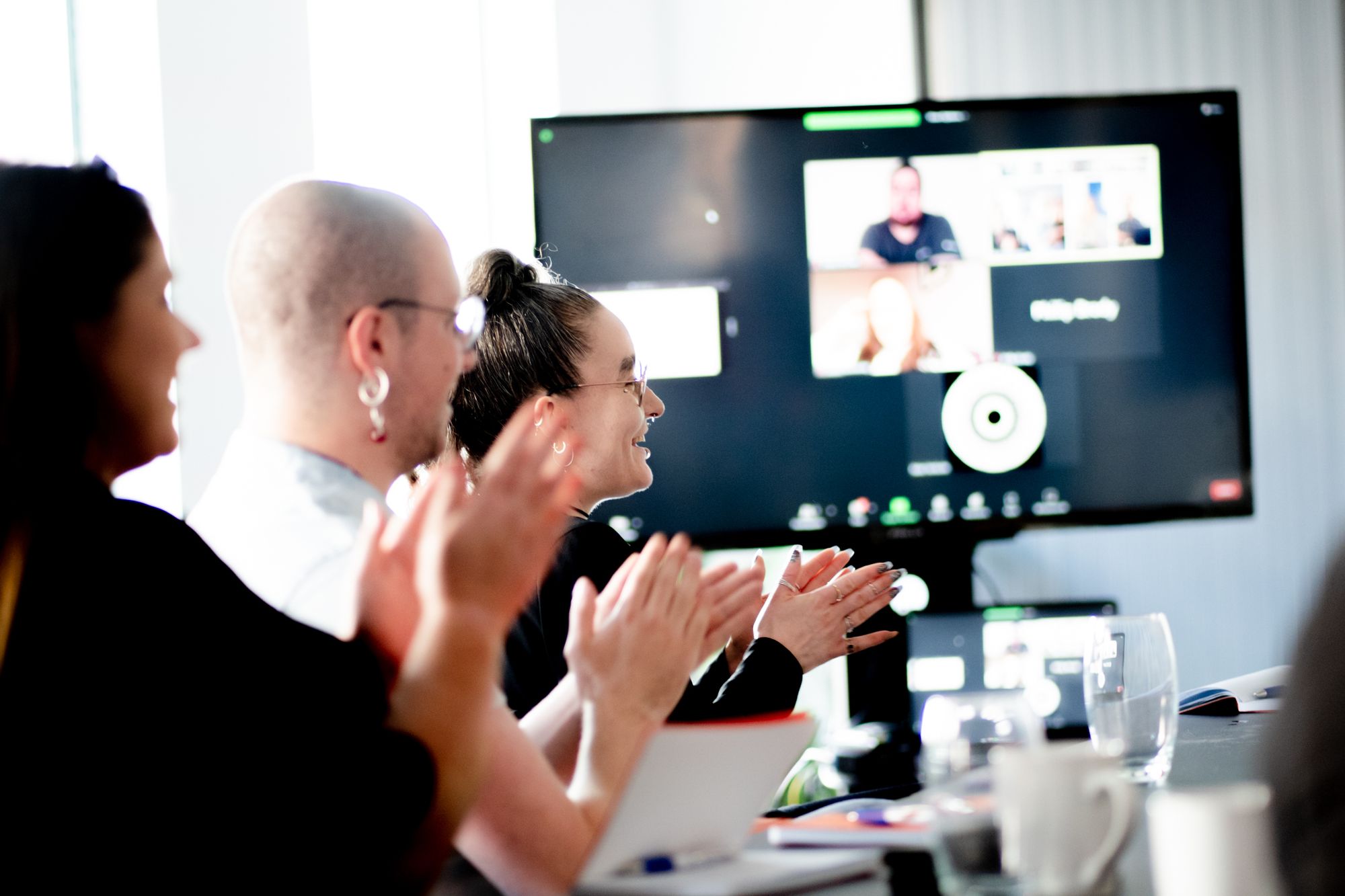 Individuals at an office desk clapping